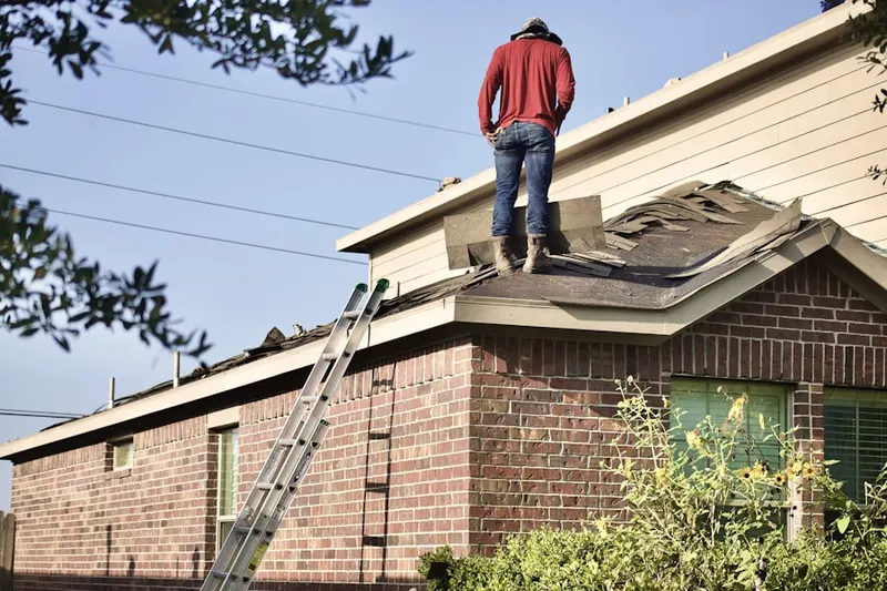 Professional roofer working on a residential roof in Solebury
